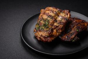 Delicious juicy beef or chicken steak with salt, spices and herbs photo