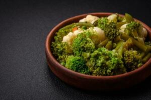 Delicious fresh vegetables steamed carrots, broccoli, cauliflower photo