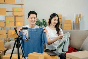 Small business entrepreneur SME freelance Asian man and woman working at home office, BOX, tablet and laptop online, marketing, packaging, delivery. photo