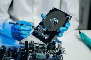 The technician is putting the CPU on the socket of the computer motherboard. electronic engineering electronic repair, electronics photo