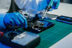 The technician is putting the CPU on the socket of the computer motherboard. electronic engineering electronic repair, electronics photo