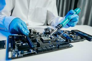 The technician is putting the CPU on the socket of the computer motherboard. electronic engineering electronic repair, electronics photo