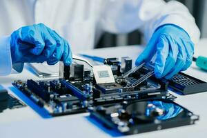 The technician is putting the CPU on the socket of the computer motherboard. electronic engineering electronic repair, electronics photo