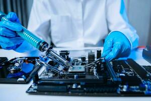 The technician is putting the CPU on the socket of the computer motherboard. electronic engineering electronic repair, electronics photo
