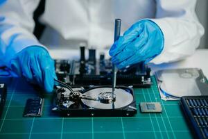 The technician is putting the CPU on the socket of the computer motherboard. electronic engineering electronic repair, electronics photo