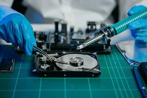 The technician is putting the CPU on the socket of the computer motherboard. electronic engineering electronic repair, electronics photo