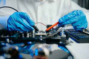 The technician is putting the CPU on the socket of the computer motherboard. electronic engineering electronic repair, electronics photo