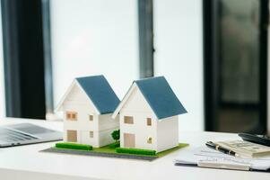 balancing the property sector The real estate agent is explaining the house style to see the house design and the purchase agreement. model house photo