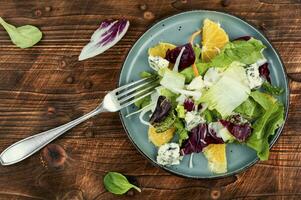 Salad with fresh greens and oranges. photo