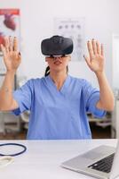 Health physician using medical inovation wearing virtual reality goggles in hospital office. Therapist using medical innovation equipment device glasses, future, medicine, physician, healthcare, professioanl, vision, simulator. photo