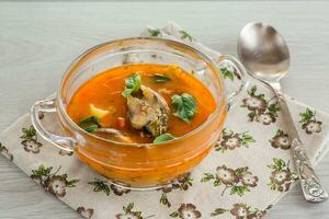 vegetable tomato soup with fish in a plate photo