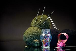 wool yarn, knitting needles and other tools for hand knitting. photo