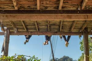 Tourists group sitting hanging legs on terrace photo