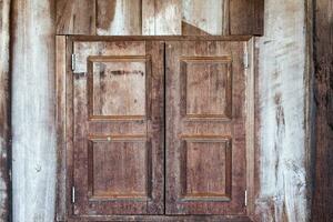 Old wooden wall and close window photo