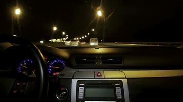 Car driving at night. Driving car in the city view from the interior. Timelapse of driving at night with camera in car photo