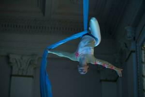 Speech gymnasts on the canvases. Girl on acrobatic canvases.Dangerous Circus Tricks.Aerial gymnast photo