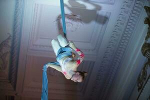 Speech gymnasts on the canvases. Girl on acrobatic canvases.Dangerous Circus Tricks.Aerial gymnast photo