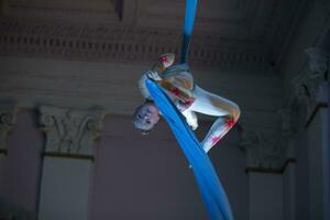 Speech gymnasts on the canvases. Girl on acrobatic canvases.Dangerous Circus Tricks.Aerial gymnast photo