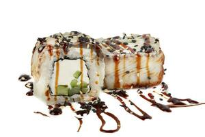 Sushi closeup isolated on white background. Sushi roll with graham rice, Philadelphia cheese and celery topped with soy sauce. photo