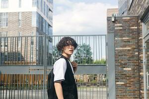 young man on the street against the urban landscape photo