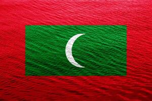 Flag of Republic of Maldives on a textured background. Concept collage. photo