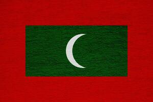 Flag of Republic of Maldives on a textured background. Concept collage. photo