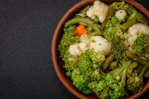 Delicious fresh vegetables steamed carrots, broccoli, cauliflower photo