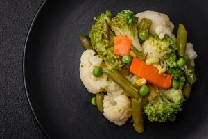 Delicious fresh vegetables steamed carrots, broccoli, cauliflower photo