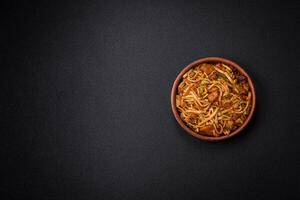 Delicious asian udon dish with vegetables, mushrooms, salt and spices photo