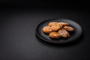 Delicious sweet round sponge cookies sprinkled with coconut flakes photo