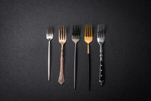 Kitchen fork made of steel on a dark textured background photo