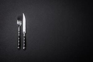 Kitchen knife and fork made of steel with copy space photo