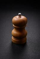 Beautiful wooden figured pepper shaker or salt shaker with a mill photo