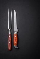 Kitchen knife and fork made of steel with copy space photo