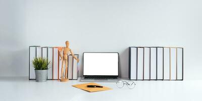 Laptop computer mockup blank white screen on table in white background. laptop with blank screen on table of workplace contemporary white background photo