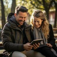 ai generado un Pareja sentado en un parque banco, utilizando un tableta a hacer un pago para concierto Entradas foto