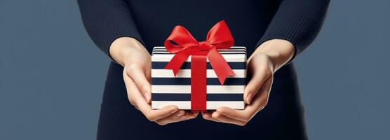 AI generated A woman's hand is holding an open christmas gift with ribbon and bow photo