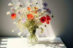 AI generated Bouquet of wildflowers in a small glass vase on the white table. Poppies, chamomiles, cornflowers, green grass. Summer photo. Contrast shadows on the white wall. Country style. photo