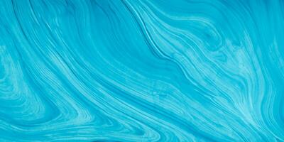 blue liquid paint on a surface with a wave pattern photo