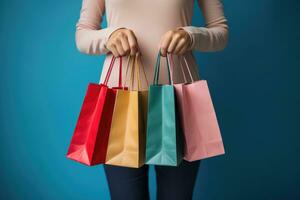 AI generated Young woman with shopping bags on color background, closeup. Black Friday sale, Female hand holding many colorful shopping bags on a blue background, AI Generated photo