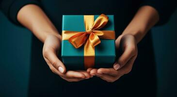 AI generated golden gift box in a woman's palm on a turquoise background photo