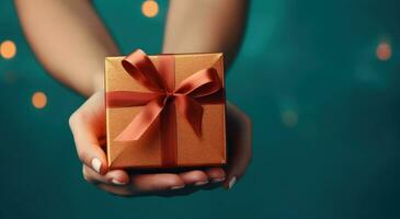 AI generated golden gift box in a woman's palm on a turquoise background photo