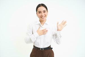 Friendly smiling businesswoman, introduces herself, says her name, stands over white background photo