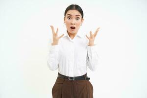 Portrait of frustrated corporate woman, gasps and looks terrified, scared of smth shocking, white background photo