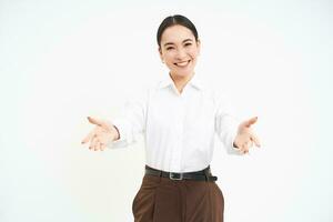 Friendly businesswoman stretches hands with warm welcome, invites clients, looks happy, white background photo