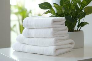 AI generated three white towel stacked next to a plant on a table photo