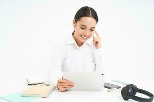 Image of saleswoman, asian entrepreneur talks on video chat from her office, has a meeting, connects to webinar online, white background photo