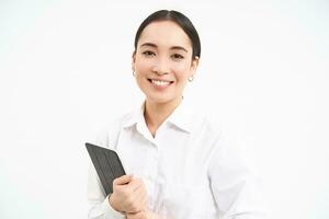 Portrait of businesswoman working on digital tablet, creating diagrams for meeting conference on gadget, standing over white background photo