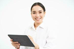 Portrait of businesswoman working on digital tablet, creating diagrams for meeting conference on gadget, standing over white background photo