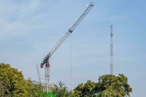 tower cranes on construction site, providing housing for low-income citizens of third world countries photo